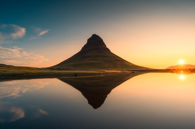 아이슬란드에서 일출 동안 호수 반사와 대칭 Kirkjufell 산