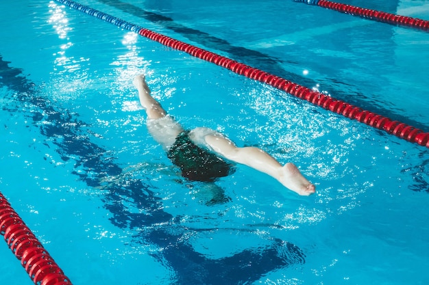 싱크로나이즈드 수영 선수가 수영장에서 혼자 훈련