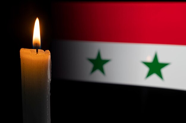 Syria Catastrophe mourning disaster Flag of syriaand a burning candle sorrow disaster earthquake in syria