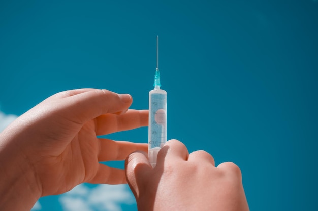 Syringe in the hands of a doctor