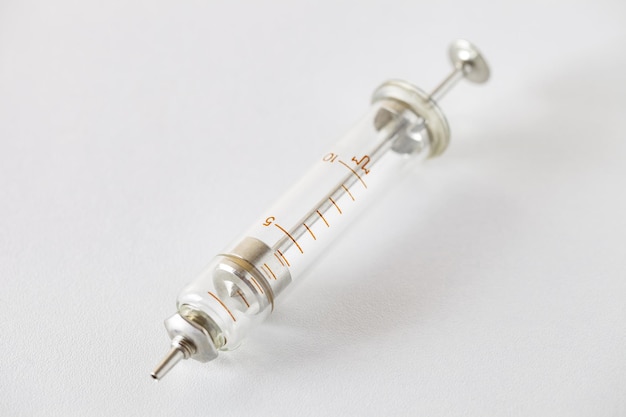 Syringe old glass with metal piston selective focus