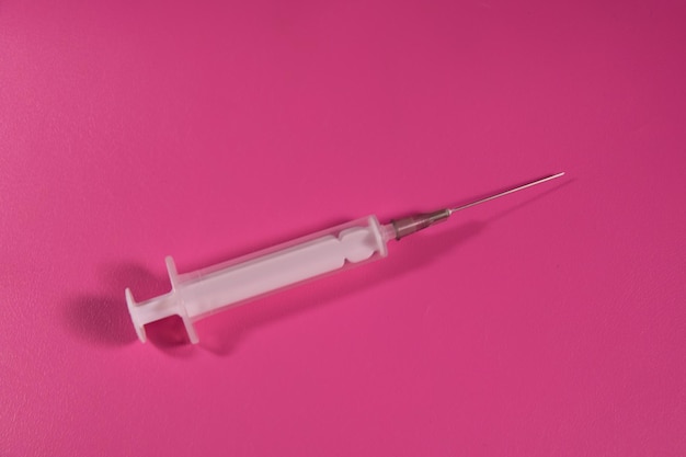 Syringe on a pink background Healthcare and medicine concept