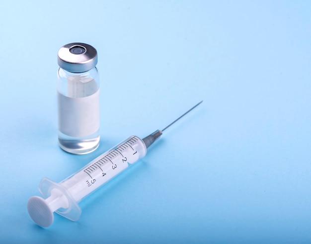 syringe on the table, medical supplies are on the table.