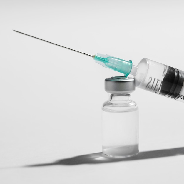 Photo syringe and vaccine arrangement close-up