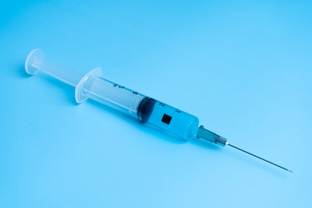 Syringe with coronavirus vaccine and a chip inside the vaccine