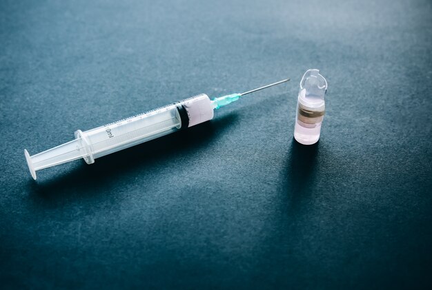 Syringe with medication in the ampule. Medical treatment of a low quality.