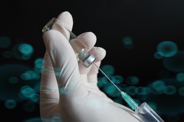 A syringe with a needle in it is being held in a hand.