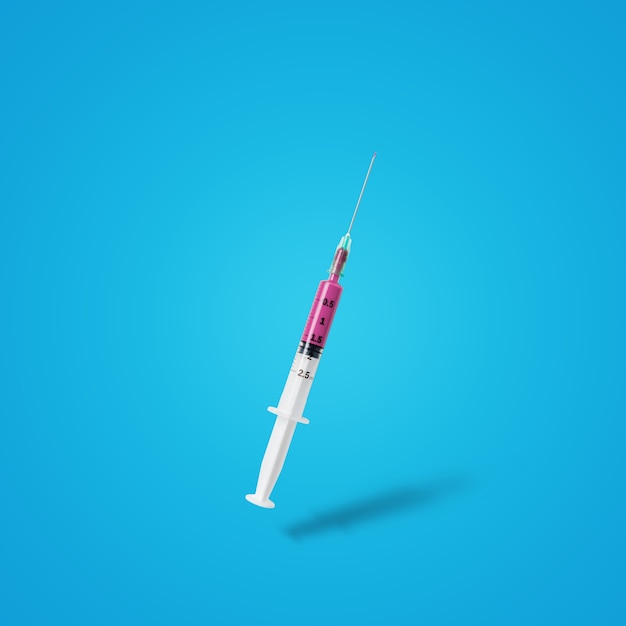 Syringe with vaccine on pastel blue background.