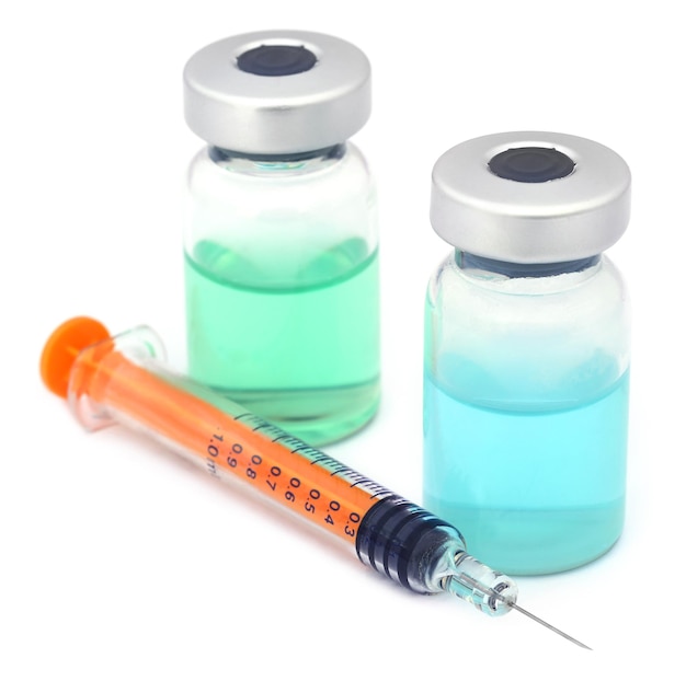 Syringe with vial over white background