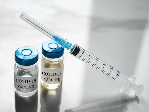 Syringes, injection bottles and tablets lying on the table