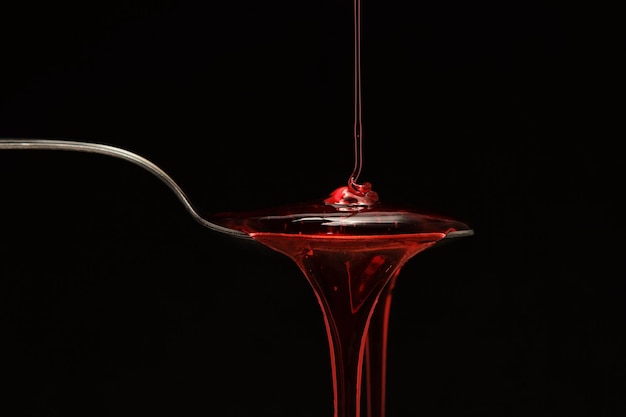 Syrup spilling into a spoon