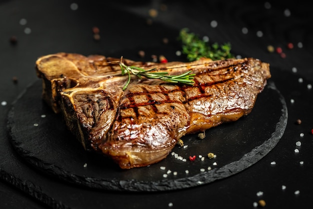 T-bone or aged wagyu porterhouse grilled beef steak with spices and herbs