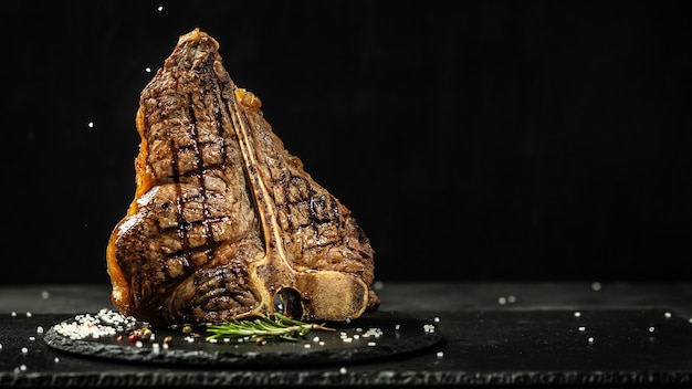 The T-bone or porterhouse steak of beef cut from the short loin. steaksT-shaped bone with meat on each side. banner, catering menu recipe place for text.