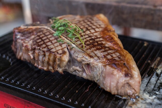 T-bone steak on grilled plate