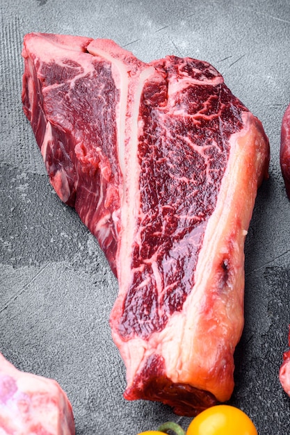 T bone steak raw set, on gray stone background