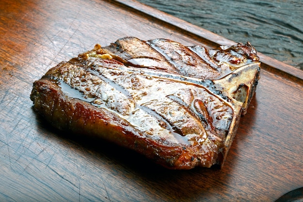 T bone steak with potato salad and vegetables