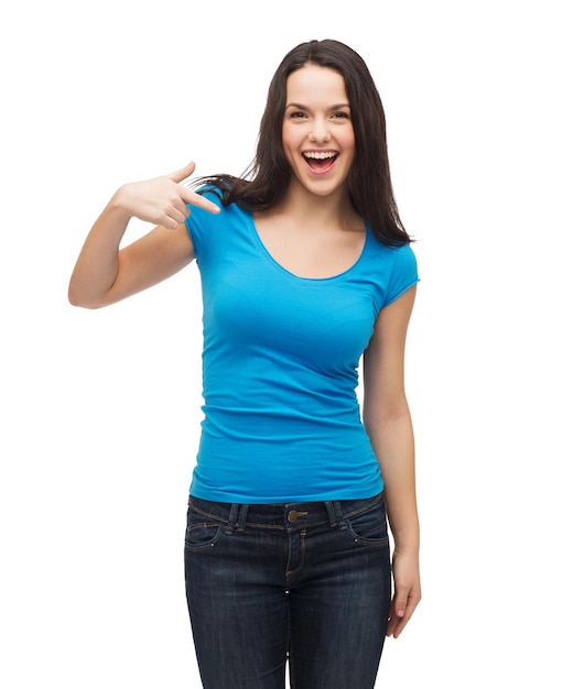 t-shirt design and gesture concept - smiling girl in blank blue t-shirt pointing her finger at herself