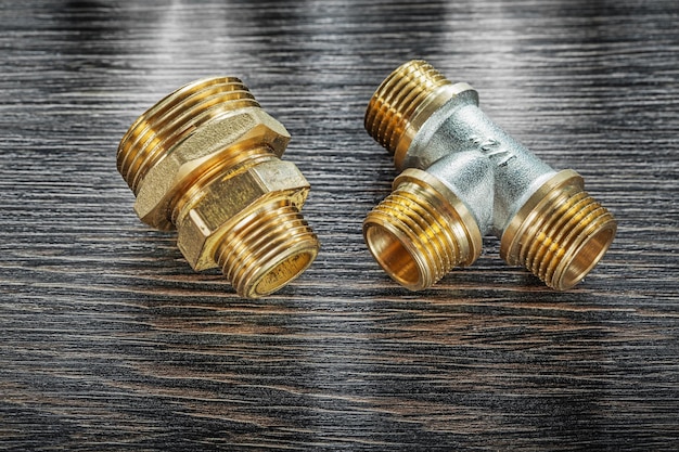 T-tube pipe connector threaded fitting on vintage wooden board.