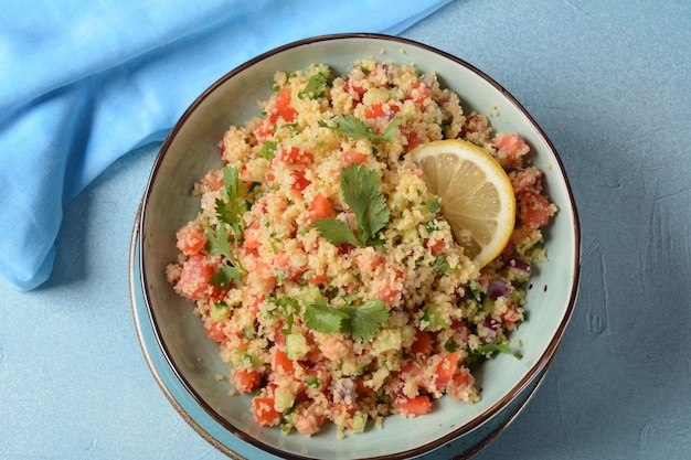 Tabbouleh a Middle Eastern cuisine vegetarian salad with chopped parsley tomatoes mint onion and bulgur and seasoned with olive oil lemon juice