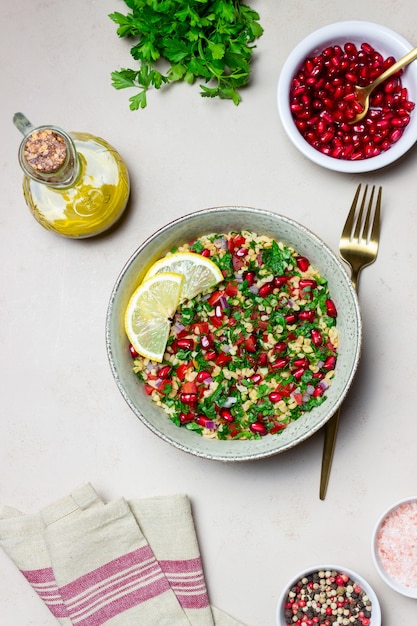 Tabbouleh salad with bulgur, mint, parsley, tomatoes and pomegranate. Healthy eating. Vegetarian food.