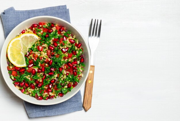 Tabbouleh salad with bulgur, mint, parsley, tomatoes and pomegranate. Healthy eating. Vegetarian food.