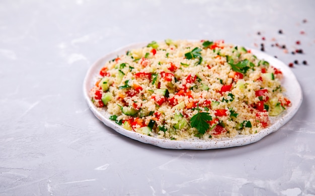 Tabbouleh salad with couscous on the plate.