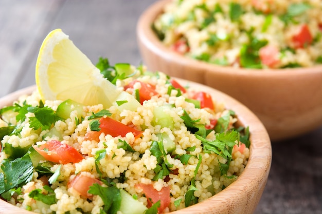 Tabbouleh salad with couscous on a rustic table