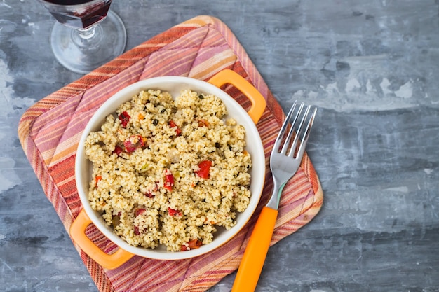 Tabbouleh in small dish on ceramic background