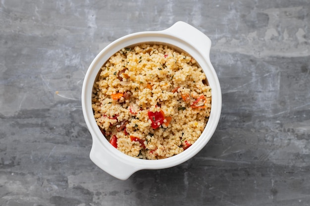 Tabbouleh on small white bowl on ceramic