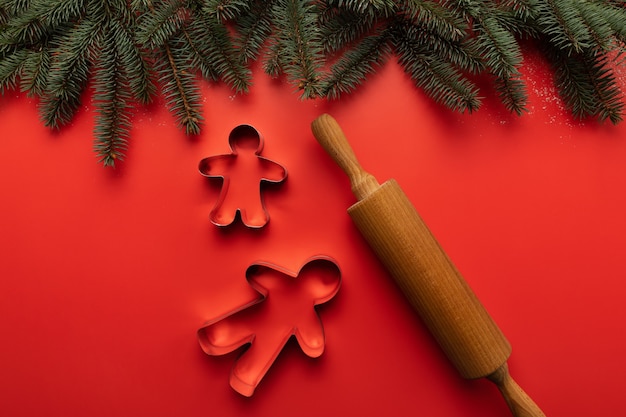 Photo on the table are tins and a wooden rolling pin for making christmas cookies