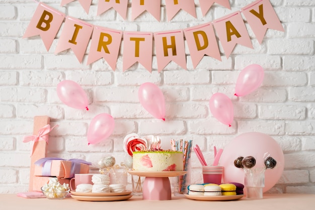 Table arrangement for birthday event with sweets and cake