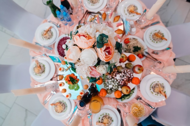 Table beautifully decorated in restaurant with different food for dinner