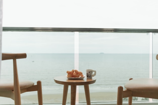 Photo table and chairs on the balcony with sea view summer concept