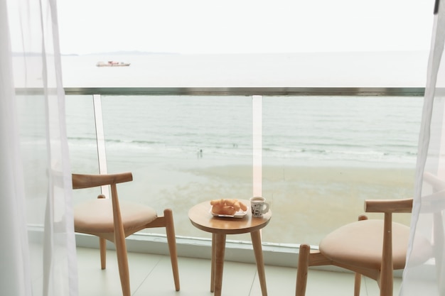 Photo table and chairs on the balcony with sea view