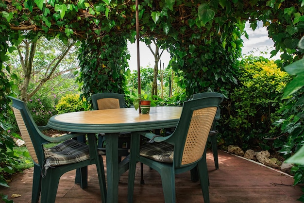 Table and chairs in a green gazebo