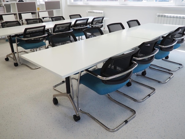 Table and chairs in the meeting room or in the auditorium White black and gray in the interior