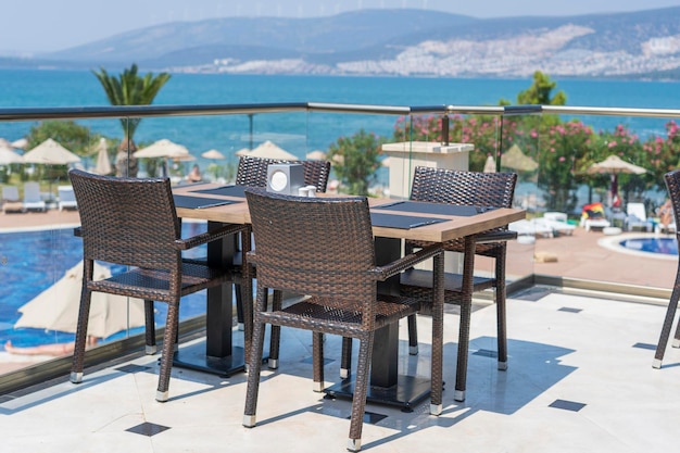 Table and chairs in restaurant Turkey Beach cafe near sea outdoors Travel and vacation concept