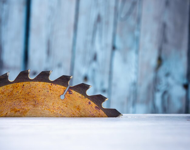 Table circular saw blade, carpenter's and carving tools, Industrial background.