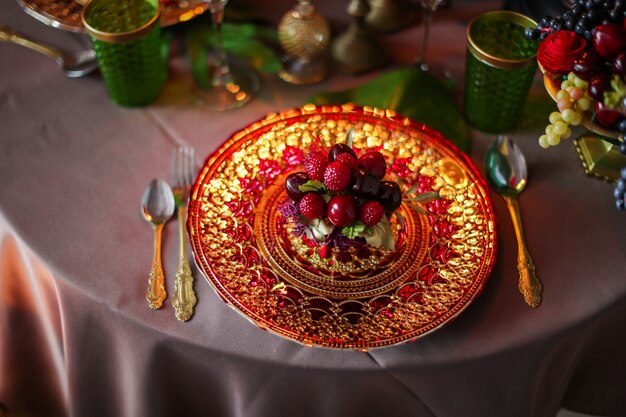 Table decorated with artificial fruits and candles