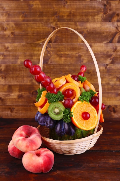 Table decoration made of fruits on wooden table on wooden wall background