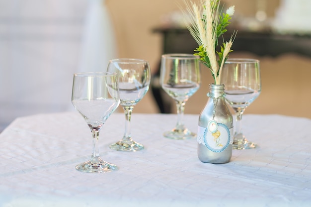 Table decoration with 4 cups and one bottle