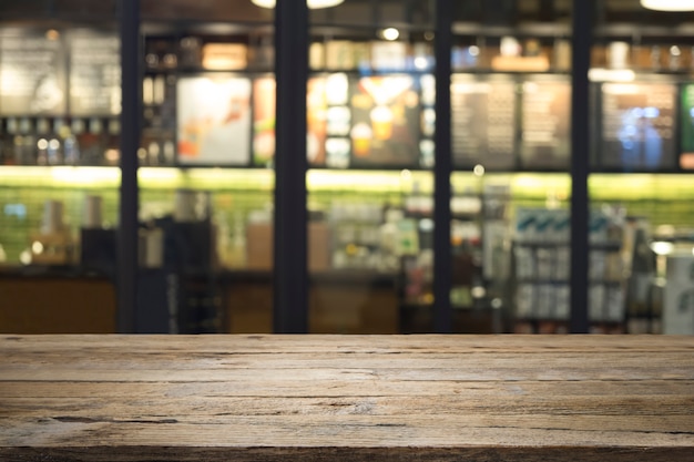 Photo table or floor with blur coffee cafe shop restaurant with bokeh background.