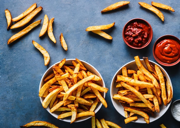 A table of french fries and ketchup