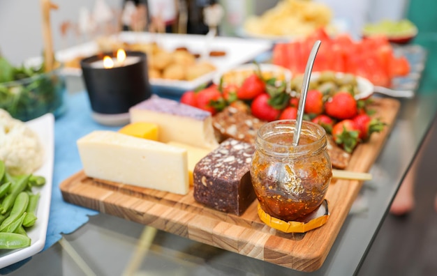 A table full of cheeses and jam