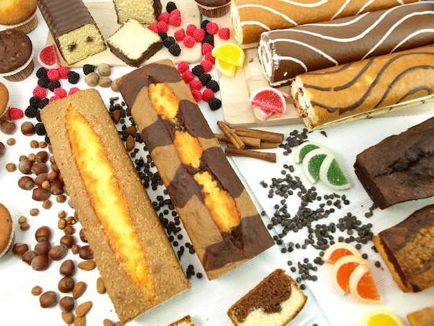 A table full of desserts including a cake and a muffin.