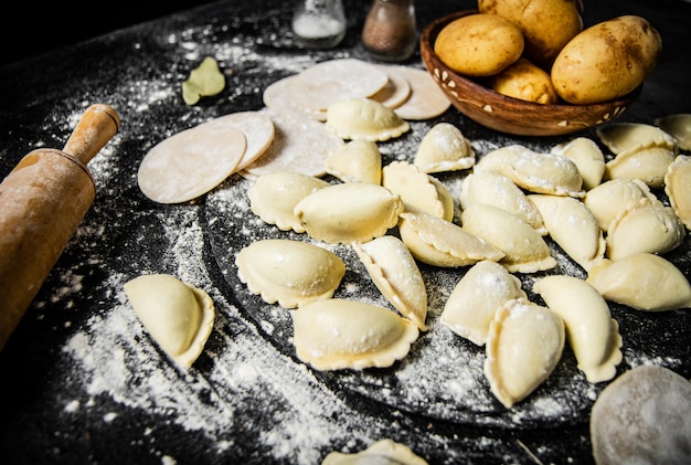 A table full of flour and flour with dumplings and bread on it