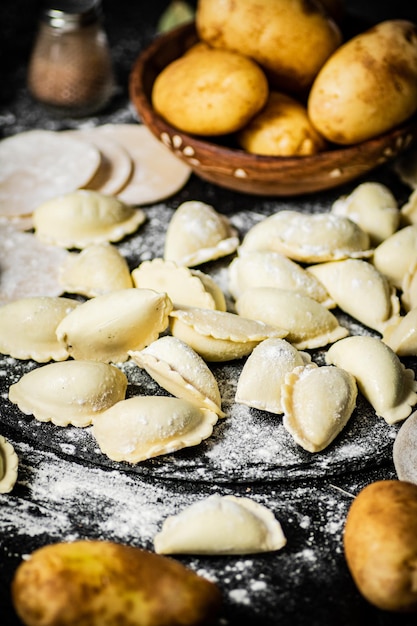 A table full of food including a plate of ravioli.