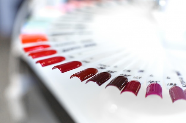 Table full of manicure utensils, manicure tools, nail polish colours on palette. Nails art accessories