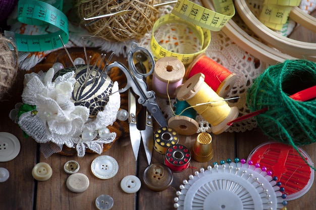 A table full of sewing supplies including a sewing machine, buttons, and other items.