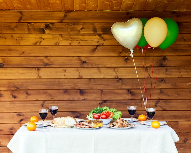 Table full of vegetables and meat air balloons on wooden